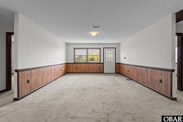 116 W Old Cove Rd Lot 1, Nags Head, NC 27959 - unfurnished room with a wainscoted wall, light carpet, and wood walls