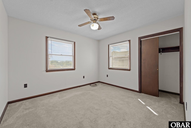 116 W Old Cove Rd Lot 1, Nags Head, NC 27959 - unfurnished bedroom featuring a closet, a textured ceiling, carpet flooring, a ceiling fan, and baseboards