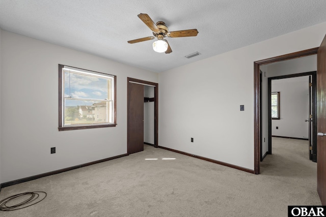 116 W Old Cove Rd Lot 1, Nags Head, NC 27959 - unfurnished bedroom with a closet, a textured ceiling, baseboards, visible vents, and light colored carpet