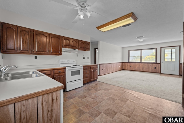 116 W Old Cove Rd Lot 1, Nags Head, NC 27959 - kitchen featuring a sink, stone finish floor, under cabinet range hood, wainscoting, and white range with electric stovetop
