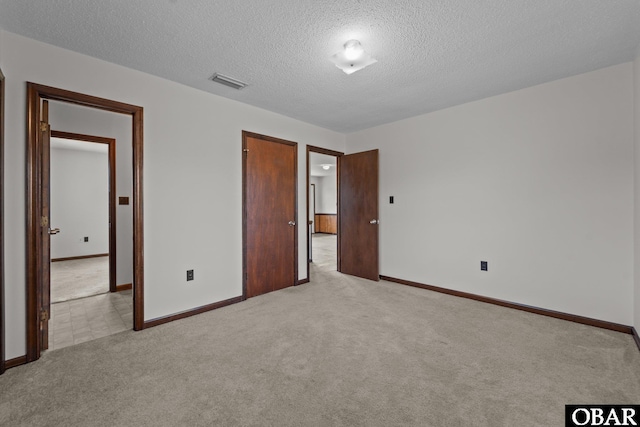 116 W Old Cove Rd Lot 1, Nags Head, NC 27959 - unfurnished bedroom with light colored carpet, a textured ceiling, visible vents, and baseboards