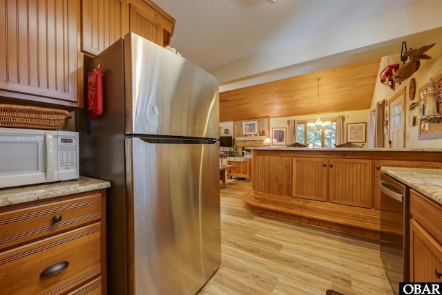 198 Duck Road Lot 24 & 25, Southern Shores, NC 27949 - kitchen with appliances with stainless steel finishes, a chandelier, light wood-type flooring, and brown cabinets