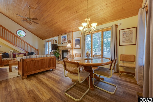 198 Duck Road Lot 24 & 25, Southern Shores, NC 27949 - dining room featuring wood ceiling, a stone fireplace, light wood-style flooring, vaulted ceiling, and a chandelier