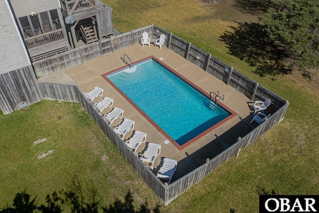 pool with a yard, fence, and a patio