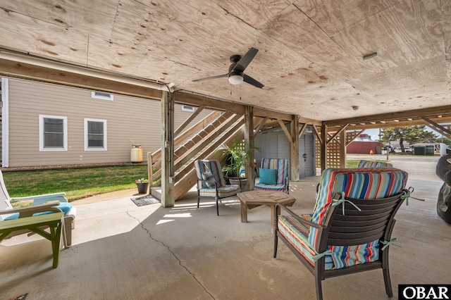 view of patio with stairs and a ceiling fan