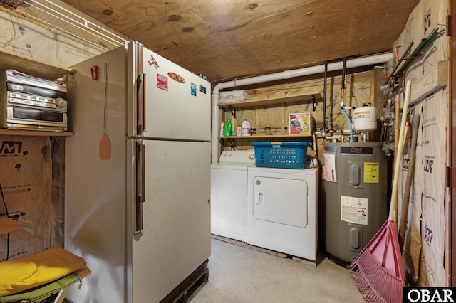 washroom with laundry area, washer and dryer, and electric water heater