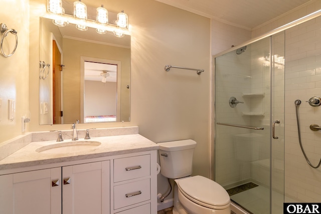 full bathroom with vanity, crown molding, toilet, and a stall shower