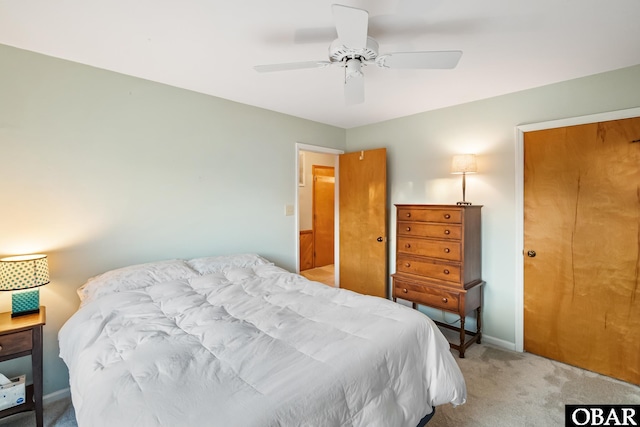 bedroom featuring light carpet, baseboards, and a ceiling fan