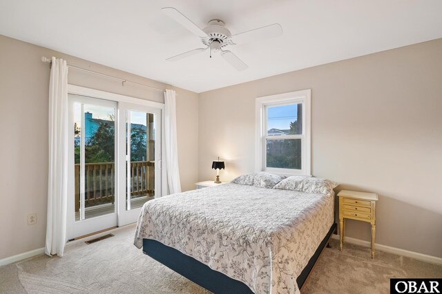 bedroom with access to outside, multiple windows, light colored carpet, and visible vents