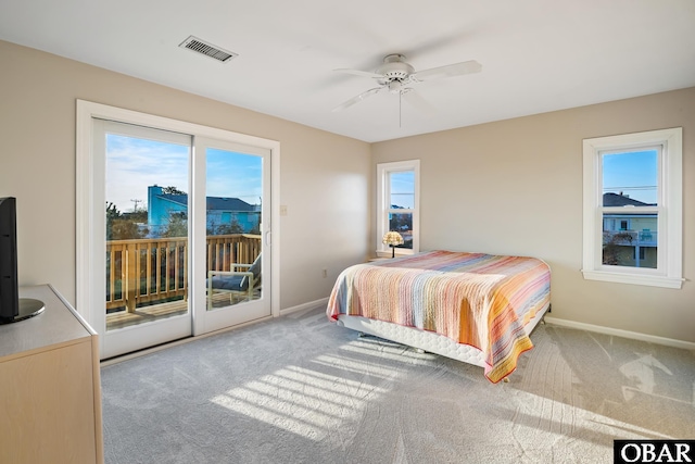 bedroom featuring visible vents, a ceiling fan, access to outside, carpet floors, and baseboards