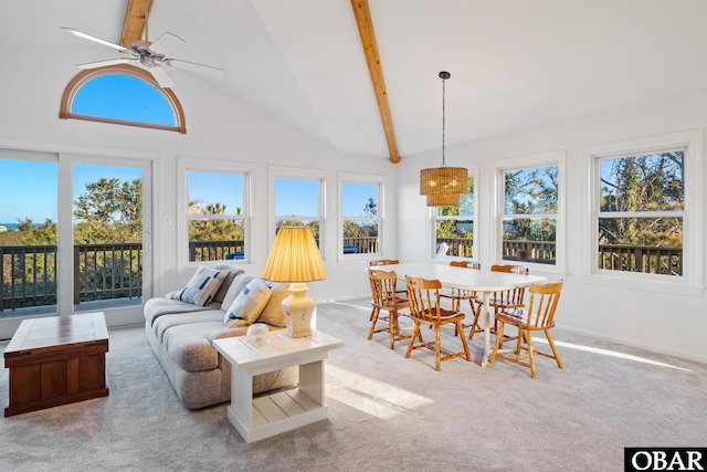 sunroom featuring lofted ceiling with beams, plenty of natural light, and ceiling fan