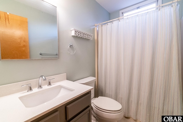 full bathroom with vanity, curtained shower, and toilet