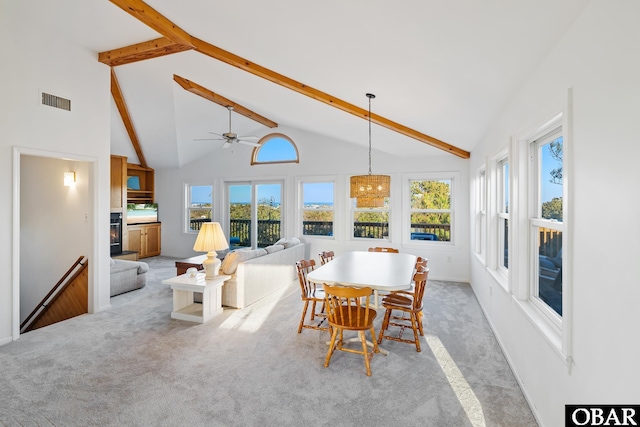 dining space with light carpet, beamed ceiling, high vaulted ceiling, and visible vents