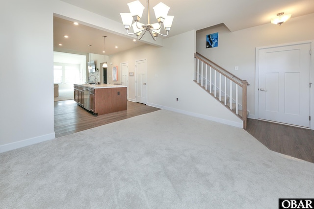 kitchen featuring a center island with sink, a sink, open floor plan, dark carpet, and recessed lighting