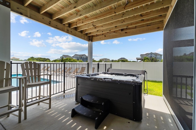 view of patio with fence private yard, a fenced in pool, and a hot tub