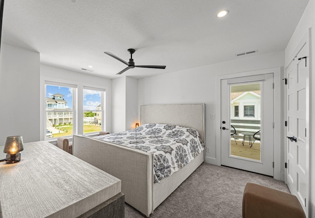 carpeted bedroom with a textured ceiling, recessed lighting, visible vents, and a ceiling fan