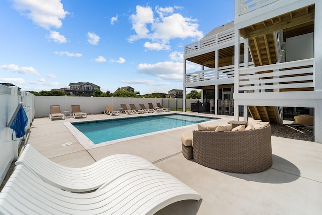 view of swimming pool featuring a fenced in pool, a fenced backyard, and a patio