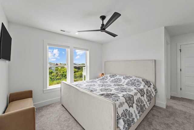 carpeted bedroom with baseboards, visible vents, and ceiling fan