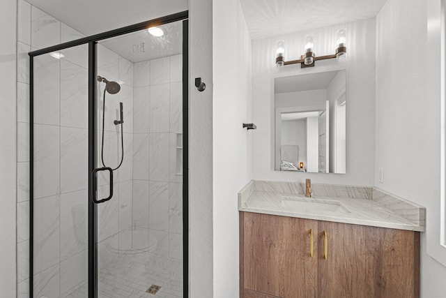 bathroom with a shower stall and vanity