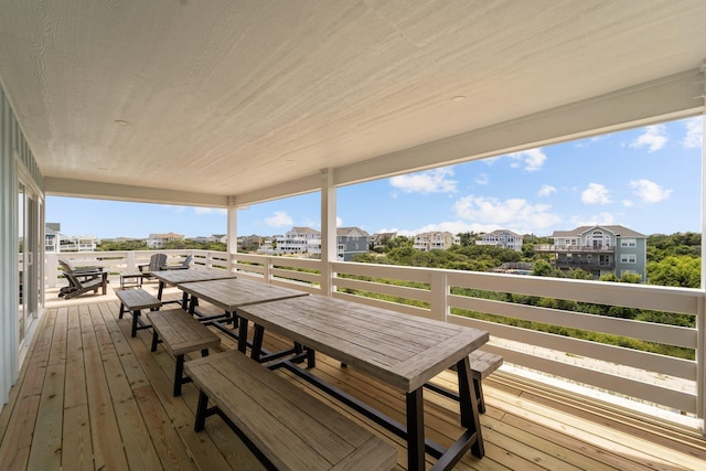 deck with a residential view and outdoor dining space