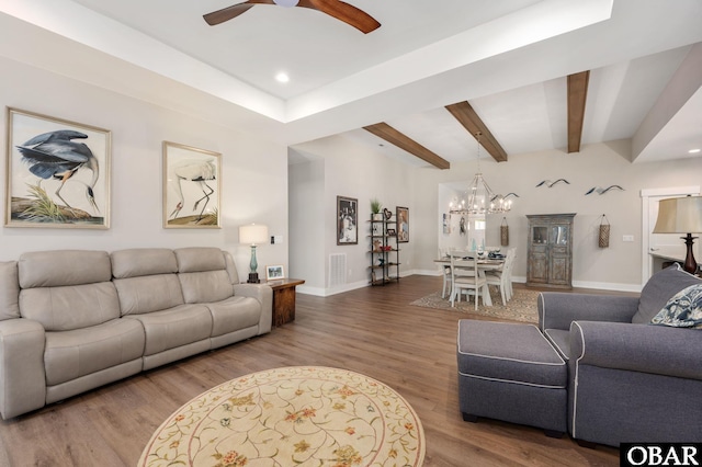 living room featuring recessed lighting, wood finished floors, beamed ceiling, baseboards, and ceiling fan with notable chandelier