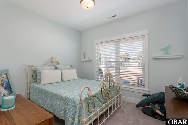 carpeted bedroom with baseboards and visible vents