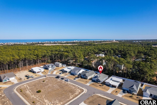 birds eye view of property with a water view and a residential view