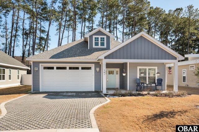 view of front of home featuring a porch, a garage, driveway, and board and batten siding