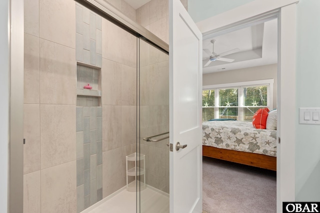 ensuite bathroom featuring ceiling fan, a stall shower, and ensuite bath