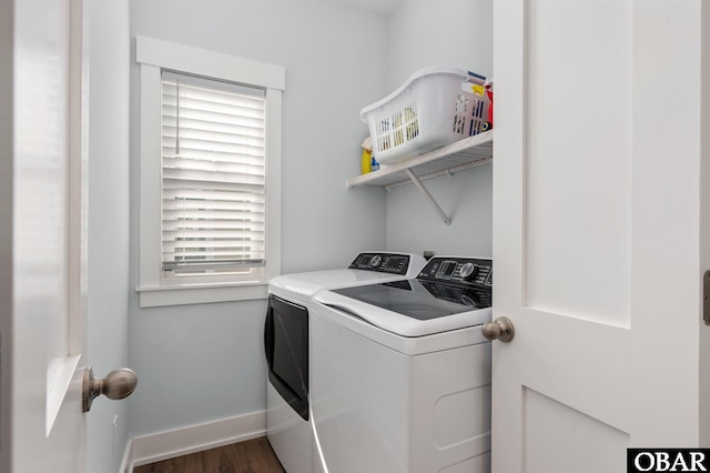 washroom with washing machine and dryer, laundry area, baseboards, and wood finished floors