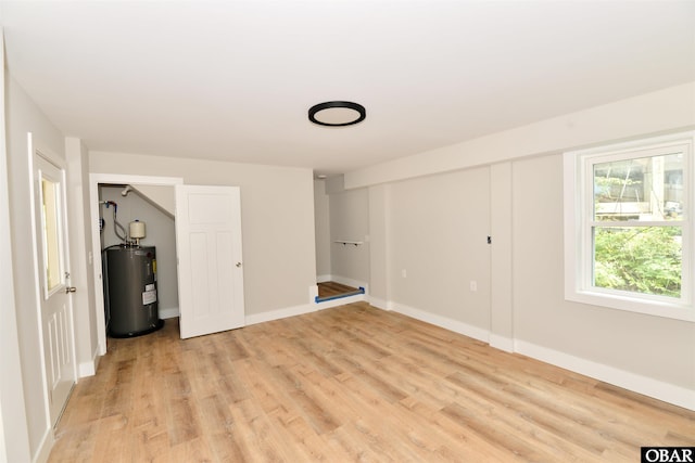 112 Mybet Ct Lot 100, Kill Devil Hills, NC 27948 - unfurnished bedroom with electric water heater, light wood-style flooring, and baseboards