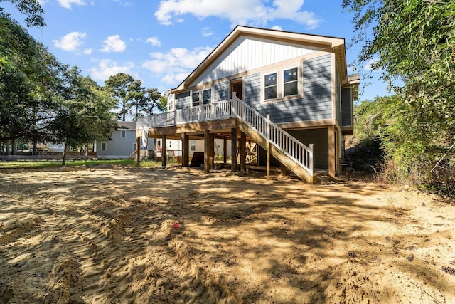 back of house with a deck and stairway