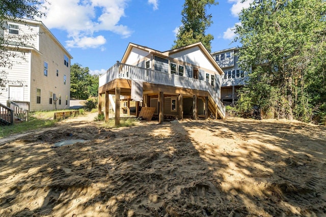 back of house featuring stairway and a deck