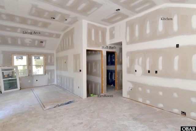 unfurnished living room featuring lofted ceiling