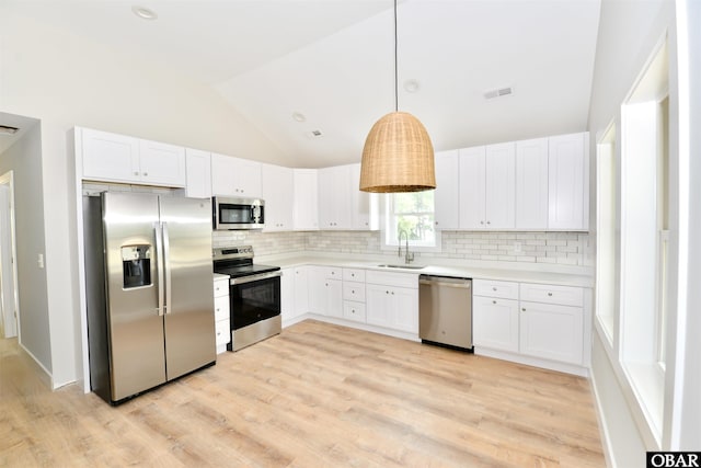 112 Mybet Ct Lot 100, Kill Devil Hills, NC 27948 - kitchen featuring stainless steel appliances, a sink, lofted ceiling, backsplash, and light wood finished floors