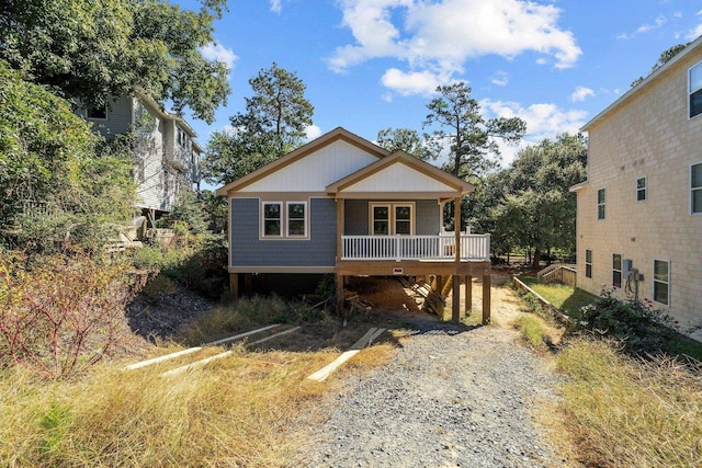 view of front of home with gravel driveway and covered porch