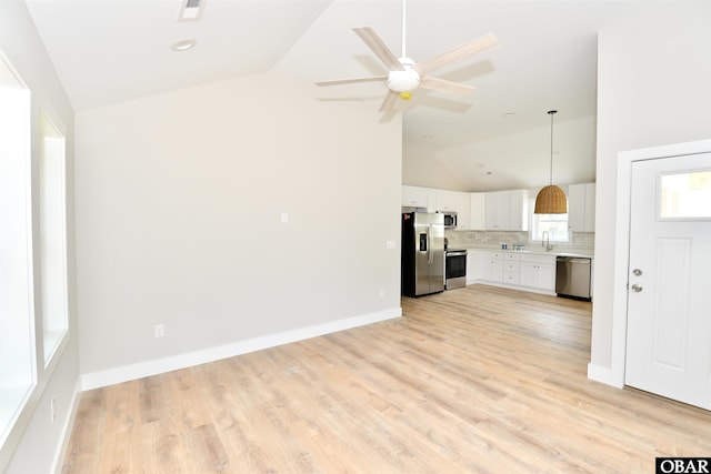 112 Mybet Ct Lot 100, Kill Devil Hills, NC 27948 - kitchen featuring appliances with stainless steel finishes, light countertops, white cabinetry, decorative backsplash, and light wood-style flooring