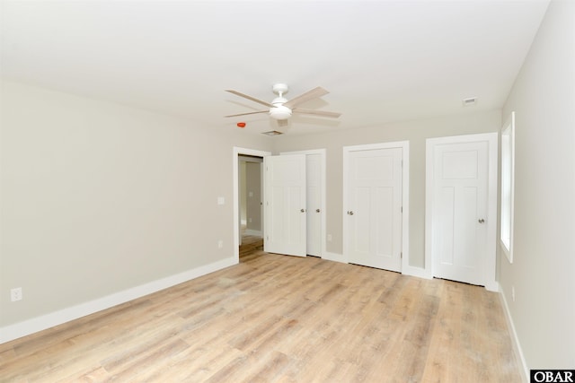 112 Mybet Ct Lot 100, Kill Devil Hills, NC 27948 - unfurnished bedroom featuring two closets, light wood-type flooring, baseboards, and ceiling fan