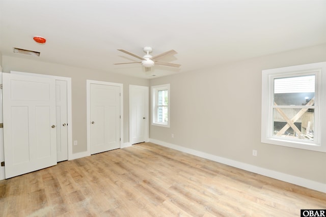 112 Mybet Ct Lot 100, Kill Devil Hills, NC 27948 - unfurnished bedroom with two closets, baseboards, and light wood finished floors