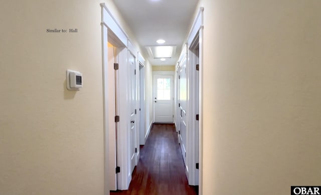 hall with dark wood-style floors and attic access