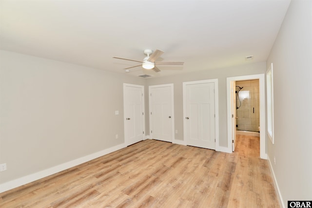 112 Mybet Ct Lot 100, Kill Devil Hills, NC 27948 - unfurnished bedroom featuring light wood-type flooring, multiple closets, a ceiling fan, and ensuite bath
