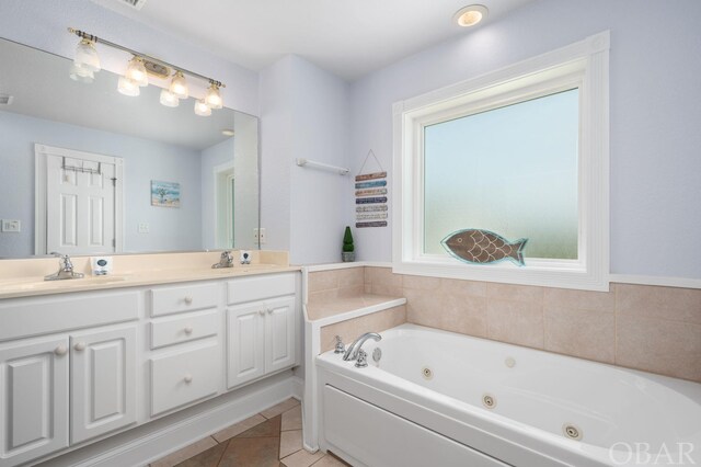 bathroom featuring double vanity, a jetted tub, a sink, and tile patterned floors