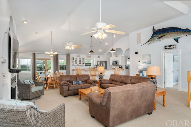 living room featuring high vaulted ceiling, ceiling fan, visible vents, and light colored carpet