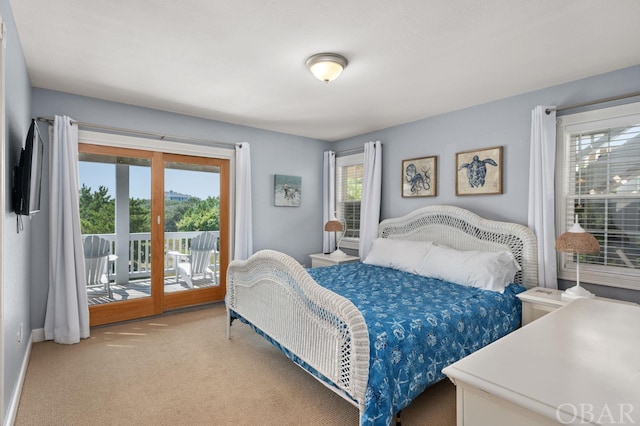 carpeted bedroom featuring baseboards, french doors, and access to exterior