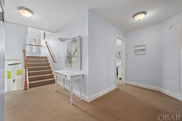 hallway with french doors, stairway, carpet flooring, and baseboards