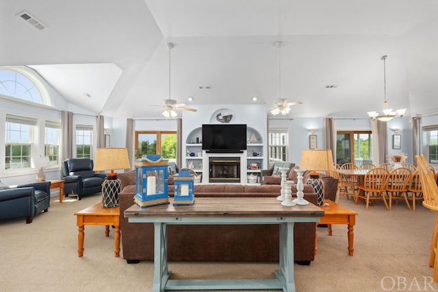 living room with plenty of natural light, light colored carpet, visible vents, and a fireplace