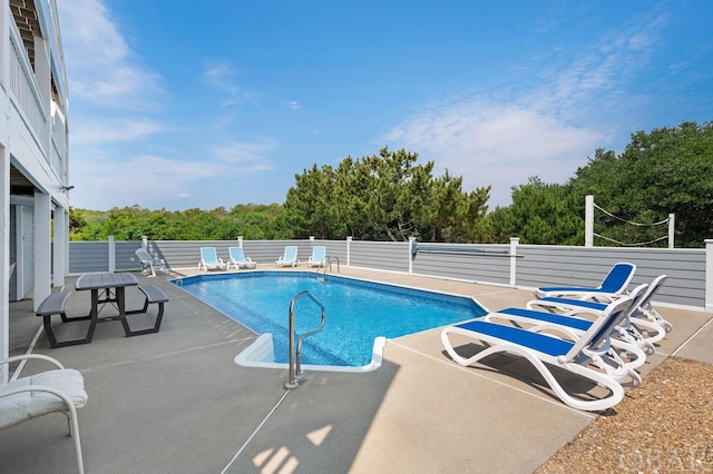 view of pool with a fenced in pool, a patio area, and fence