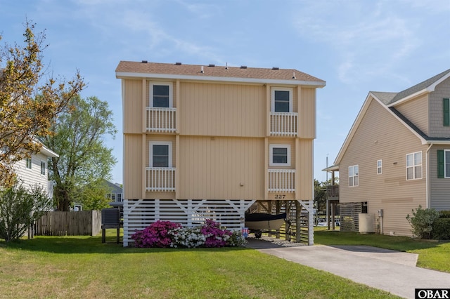 227 Outrigger Dr Lot 132, Kill Devil Hills, NC 27948 - rear view of property with stairway, a yard, a carport, central AC, and fence