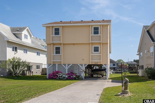 227 Outrigger Dr Lot 132, Kill Devil Hills, NC 27948 - back of house featuring driveway and a yard