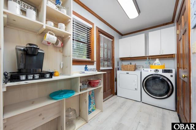 718 Canal Dr Lot 308, Kill Devil Hills, NC 27948 - washroom featuring cabinet space, crown molding, light wood-style flooring, and washer and dryer